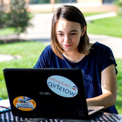 Female student pays her deposit on a computer